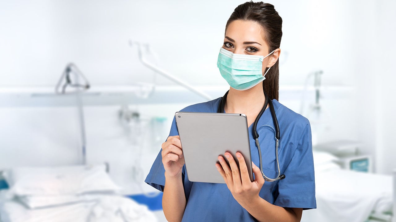 Image of healthcare worker using medical software and practicing agile or Scrum